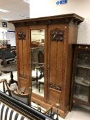 A late Victorian oak wardrobe in the Art Nouveau manner,