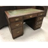 A mid 20th Century mahogany double pedestal desk with tooled leather insert over three frieze