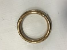 An unmarked gold bangle, the inside inscribed "Mabel M H Adcock, 15 Embassy Court,