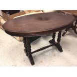 A Victorian mahogany oval centre table on twin turned end pillar supports to splayed feet (probably