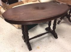 A Victorian mahogany oval centre table on twin turned end pillar supports to splayed feet (probably