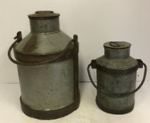 Two vintage style milk churns of different size,