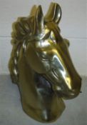 A gold coloured cast aluminium horse head ornament 45cm high