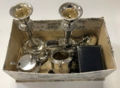 A box containing assorted plated wares to include a pair of plated candlesticks, a WMF mug,