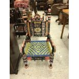 A 20th Century Indian painted throne type chair in the 19th Century manner with all-over bobbin and