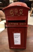 A modern vintage style red painted post box inscribed "GVI R Letters Only" Size approx 59cm high x