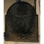 A large fire back decorated with twin headed eagle,