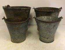 Four vintage style metal pails of varying sizes,