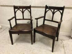 A pair of 19th Century oak Gothic arch back dining chairs with shaped panel seats on square tapered