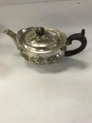 A Victorian embossed silver teapot of oval form,