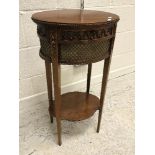 A 20th Century mahogany sewing table in the Regency style with brass embellished decoration,