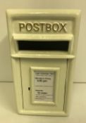 A modern white post box,