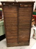 An early 20th Century oak double tambour front office cabinet, 87 cm wide by 151.