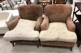 A pair of modern brown velour upholstered deep armchairs in the manner of Howard of London raised