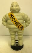 A modern cast metal "Michelin" figure stood on a tyre,