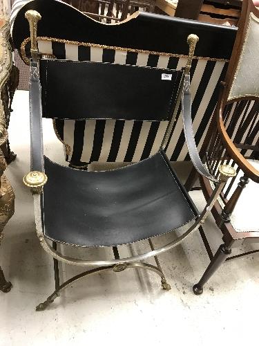 A steel framed brass embellished and leather X frame chair in the Regence taste,