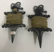 Two garden string holders with watering can finials