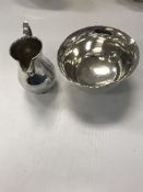 A silver baluster cream jug (by Bryan Savage,