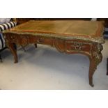 A kingwood and gilt bronze / brass embellished bureau plat in the Louis XV taste,