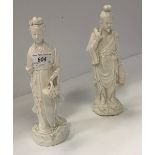 Two Chinese blanc de chine figures of a fisherman and woman with basket of leaves,