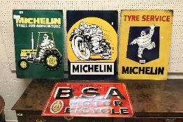 A collection of four reproduction metal signs including "Ride a B.S.A.