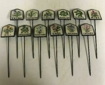 A set of twelve cast metal painted herb signs inscribed "Dill", "Thyme", "Tarragon", "Rosemary",