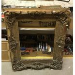 A giltwood picture frame approx 74cm high x 59cm wide to the inside and 110cm x 97cm to the outside,