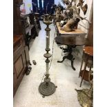 A cast brass and wrythen clear glass column standard lamp in the 19th Century Continental taste,