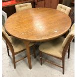 A G Plan style teak circular extending dining table on rounded supports by Mackintosh,