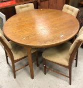 A G Plan style teak circular extending dining table on rounded supports by Mackintosh,