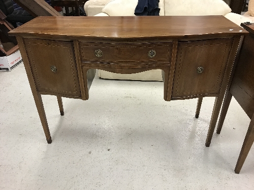 An Edwardian mahogany and inlaid serpentine fronted sideboard with central drawer flanked by two