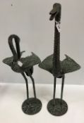 A pair of verdigris patinated bronze figures of Cranes in the Japanese style,