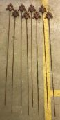 A set of eight garden stakes,