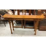 A 20th Century Chinese elm altar-style side table with scroll-work carved decoration on square