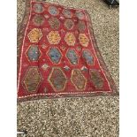 A Kelim rug, the central panel set with repeating medallions on a red ground, within a red, blue,