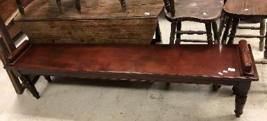 A mahogany window seat in the Victorian manner, the plain top with turned and ringed side handles,