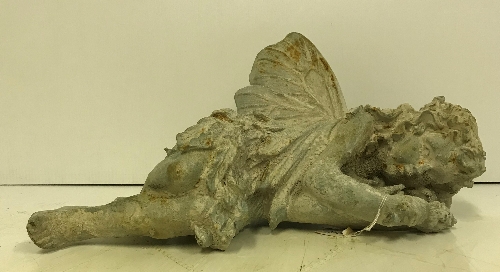 A modern cast metal sleeping Fairy figure with verdigris and rust effect patination,