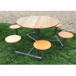 A wooden topped metal framed six seat garden table with integral seats,