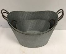 Two large oval galvanised planters 65 cm wide and a single smaller to match