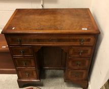 A burr walnut kneehole desk in the early 18th Century manner,