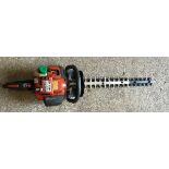 An Husqvarnae-Tech 325 HD60 X-Series hedge trimmer