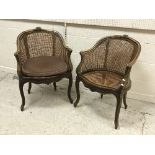 A near matching pair of circa 1900 stained beech and caned elbow chairs in the Louis XV taste,