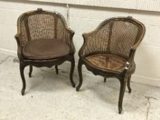 A near matching pair of circa 1900 stained beech and caned elbow chairs in the Louis XV taste,