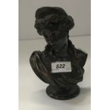 A patinated bronze bust of a classical maiden signed verso within the casting “V Carrier”,