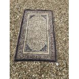 A Chinese rug, the central panel set with geometric design on a cream ground, within a cream,