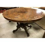 A Victorian burr walnut oval loo table on quadruped base and castors,