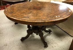 A Victorian burr walnut oval loo table on quadruped base and castors,