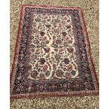 A Persian rug, the central panel set with all over foliate decoration on a cream ground,