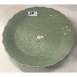 A 19th Century Chinese celadon glazed dish with underglaze incised foliate decoration,