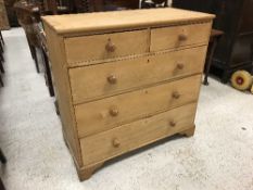 A stained pine chest of two short over three long drawers on bracket feet,